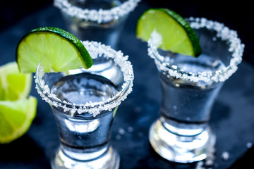 Set for tequila party with lime and salt on black background