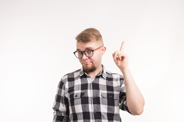 Naklejka premium Geek, nerd and education concept - Handsome man in plaid shirt finger gesture up over white background