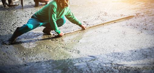 Workman plaster at construction site,Concrete pouring during commercial concreting floors.