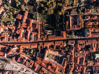 Aerial top view of hexagonal square in European city, with townhouses brick roofs