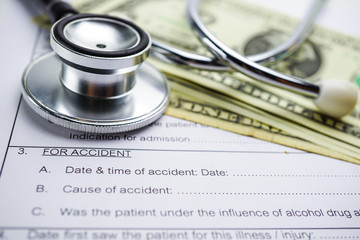 Health insurance accident claim form with coin money and car.      
