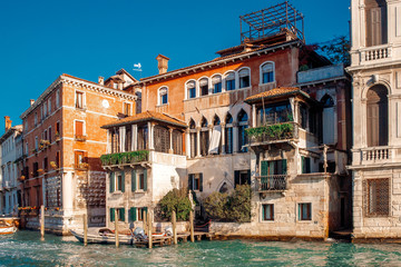 Naklejka premium Small canals boats, old brick houses Venetian style Venice, Italy.
