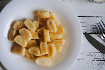 Dumplings with sour cream in a white plate