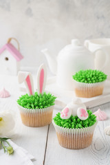 Set of Easter cupcakes for kids. Funny bunny butt and ears.