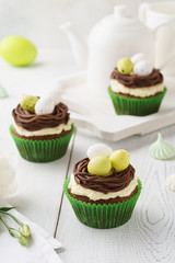 Easter chocolate cupcakes decorated with nest and candy eggs.