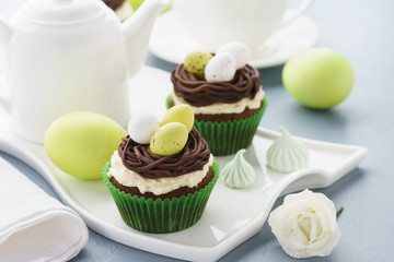 Easter chocolate cupcakes with nest and eggs for dessert.