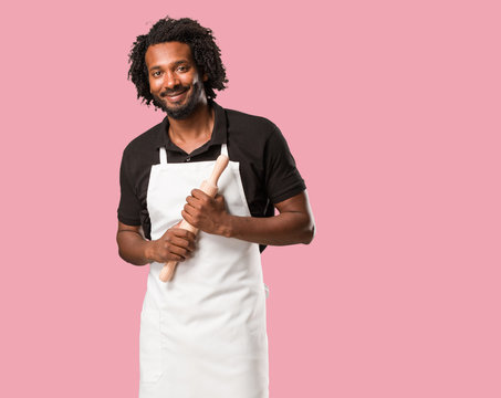 Handsome african american baker crossing his arms, smiling and happy, being confident and friendly