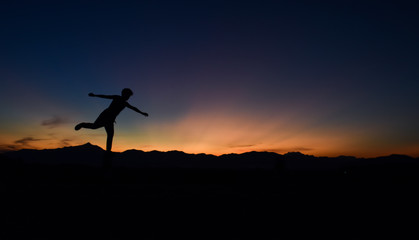 Silhouette of man doing walking at sunset, Concept lifestyle freedom vacation travel.