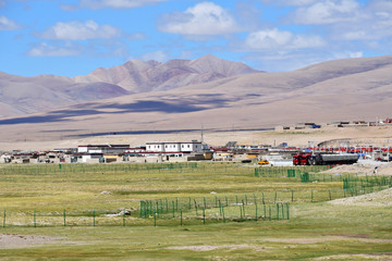 China, Tibetan plateau. Mountain settlement Yakra in summer in sunny day