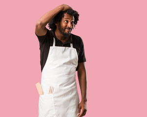 Handsome african american baker worried and overwhelmed, forgetful, realize something, expression...