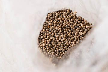 Fototapeta na wymiar Package of Organic Dry Coriander Seeds