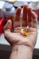 Man's hand with a bunch of pills