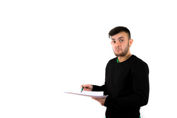 Confused and surprised bearded young man nice and modern holding some documents and pen isolated on a white background