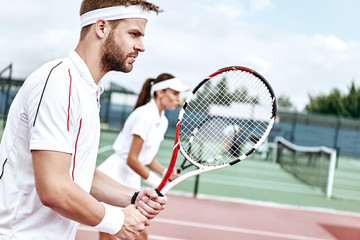 Teamwork. Beautiful woman and handsome man are competely focused on the game