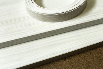 Chipboard. Plastic and paper edge wrapping of furniture.