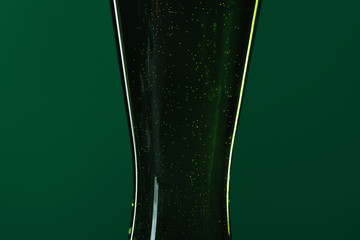 close up of beer glass isolated on green, st patrick day concept
