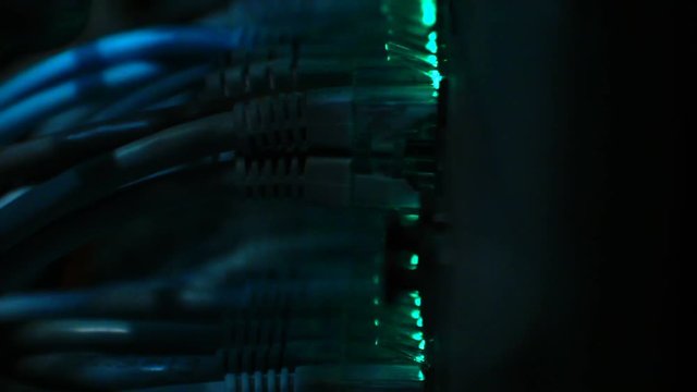 Macro, close up of LED lights on Ethernet Switch, sending and receiving data through the network.
