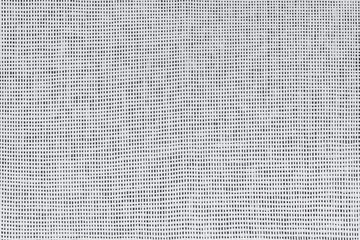 Canvas textile texture of white fibers on a dark background. Plain weave, close up