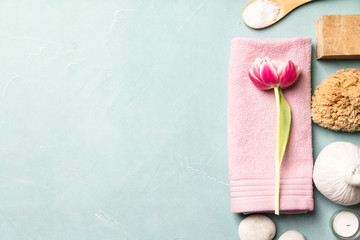 Flat lay of spa treatment set with pink flowers