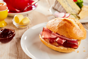 Slices of crispy bacon in fresh white bread bun