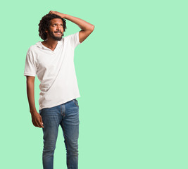 Handsome african american worried and overwhelmed, forgetful, realize something, expression of...