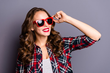 Naklejka premium Close up portrait of amazing she her lady hand on red dark bright summer glasses specs ready to meet adventures airport railway bus wearing casual checkered shirt isolated on grey background