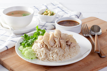Hainanese chicken rice , Steamed chicken with rice, Khao Mun Kai on wood background