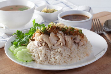 Hainanese chicken rice , Steamed chicken with rice, Khao Mun Kai on wood background