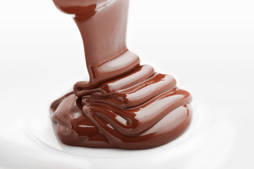 Ribbons of melted white chocolate being poured