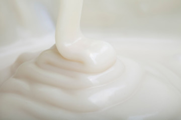 Ribbons of melted white chocolate being poured