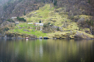 Fototapeta na wymiar view of a small Norwegian village and traditional, wooden, residential buildings on the shore of the fjord. Norway.