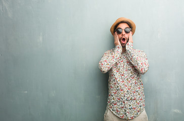 Fototapeta premium Young traveler man wearing a colorful shirt frustrated and desperate, angry and sad with hands on head