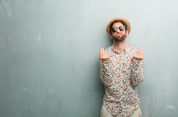Young traveler man wearing a colorful shirt sad and depressed, making a gesture of need, restoring...