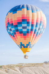 Obraz premium colourful hot air balloon floating over the valley in Turkey, Cappadocia 