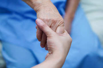 Holding hands Asian senior or elderly old lady woman patient with love, care, encourage and empathy...