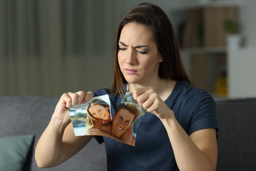 Angry girl breaking a couple photo after breakup