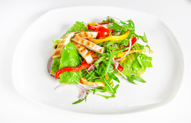 Delicious salad with meat, tomatoes and greenery on white