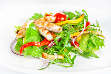 Delicious salad with meat, tomatoes and greenery on white