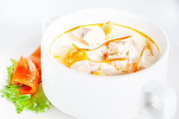 Delicious creamy soup with salmon on white