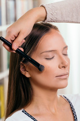 Make up artist working with a client