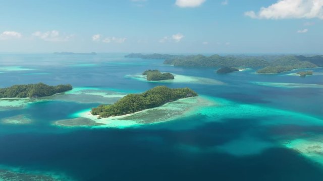 Aerial view of South Rock Islands (Chelbacheb), lush green islets around Mecherchar island, seascape with colorful coral reefs and tropical lagoons - landscape panorama of Micronesia from above, Palau