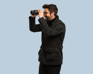 Fototapeta premium young man looking through the binoculars