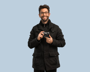 young man holding a camara