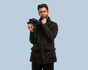 young man holding a binoculars