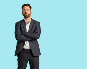 Young handsome business man crossing arms relaxed