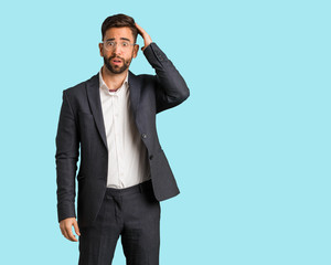 Young handsome business man worried and overwhelmed