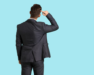Young handsome business man from behind thinking about something