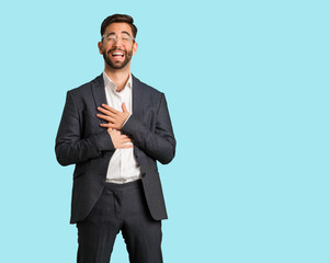 Young handsome business man laughing and having fun