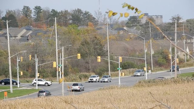 4K Traffic Lights And Iintersection From Distance With Houses In Background