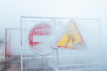 Metal fence at the scene of the accident - severe frost - steam and fog at the scene - warning signs